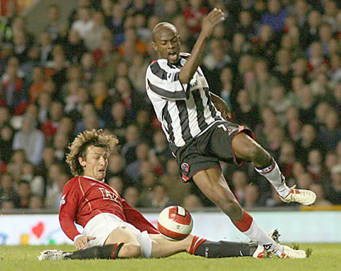 Gabriel Heinze tackles a Newcastle player, when he played for Manchester United