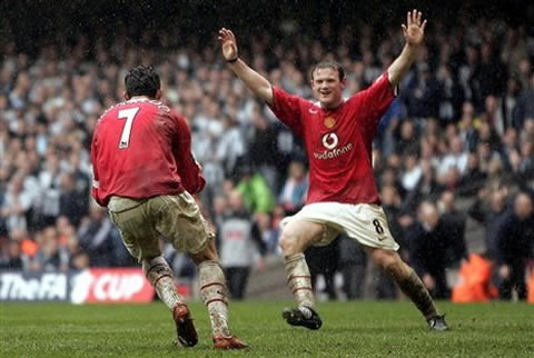 Wayne Rooney and Cristiano Ronaldo celebrating a goal for Manchester United, in a rainy day