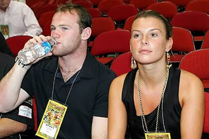 Wayne Rooney and girlfriend/wife, Coleen McLoughlin sitting close