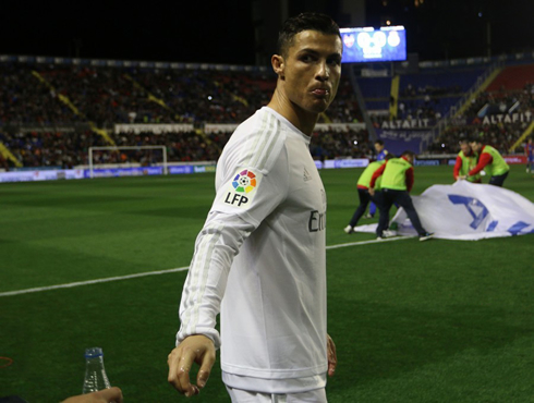 Cristiano Ronaldo looks back to retrieve a water bottle, ahead of a league game in Spain