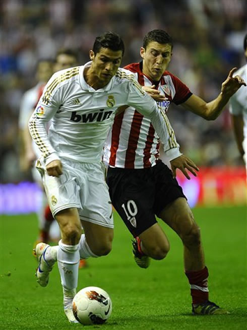 Cristiano Ronaldo holds an Ahtletic Bilbao player charge, in a game for La Liga 2012