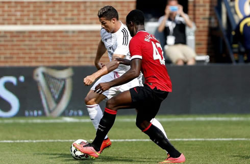 Cristiano Ronaldo taking on a defender in Real Madrid vs Manchester United, in Michigan