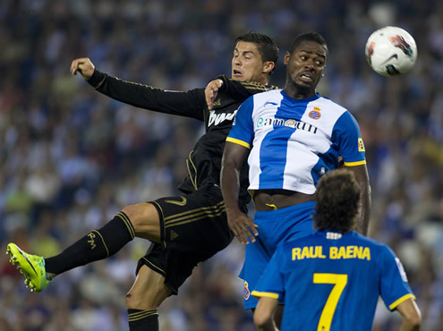 Cristiano Ronaldo jumping to head a ball, near a Espanyol defender