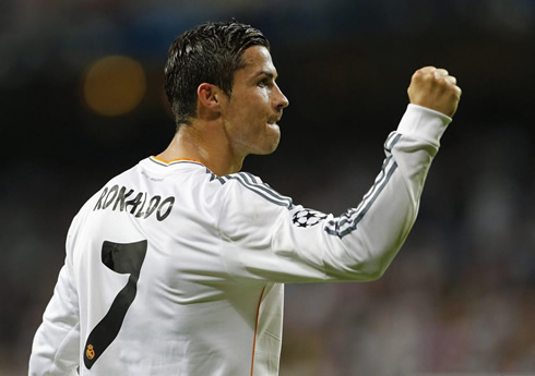 Cristiano Ronaldo biting his tongue and showing his fist closed, as a sign of strength