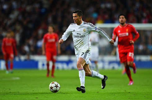 Cristiano Ronaldo running forward with the ball in the Santiago Bernabéu, in a Champions League match between Real Madrid and Liverpool
