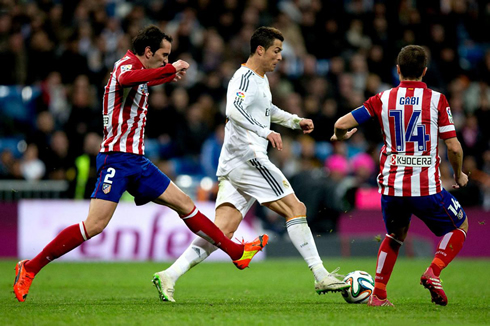 Cristiano Ronaldo trying to get past two Atletico Madrid defenders