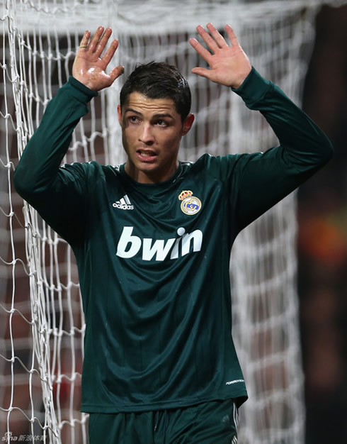 Cristiano Ronaldo raising his two hands in a sign of apologies towards Manchester United fans and supporters, after scoring Real Madrid goal at Old Trafford, in 2013