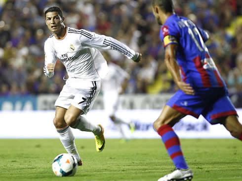 Cristiano Ronaldo running after the ball with his eye set on his opponent