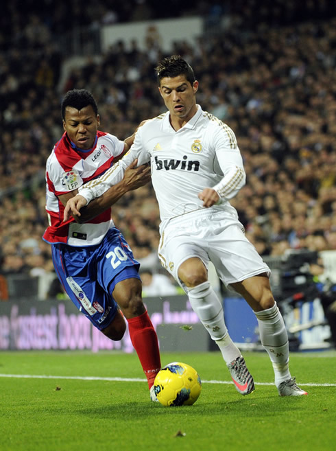 Cristiano Ronaldo running with the ball while being pushed