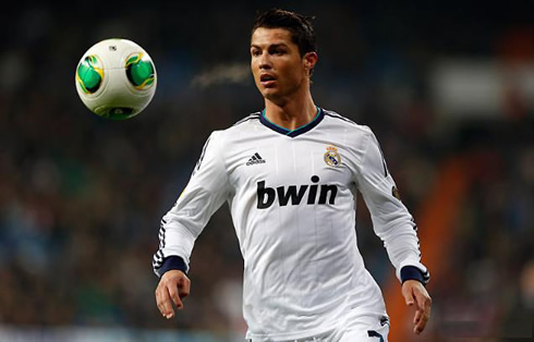 Cristiano Ronaldo looking at the ball bouncing in front of him, in Real Madrid 2013