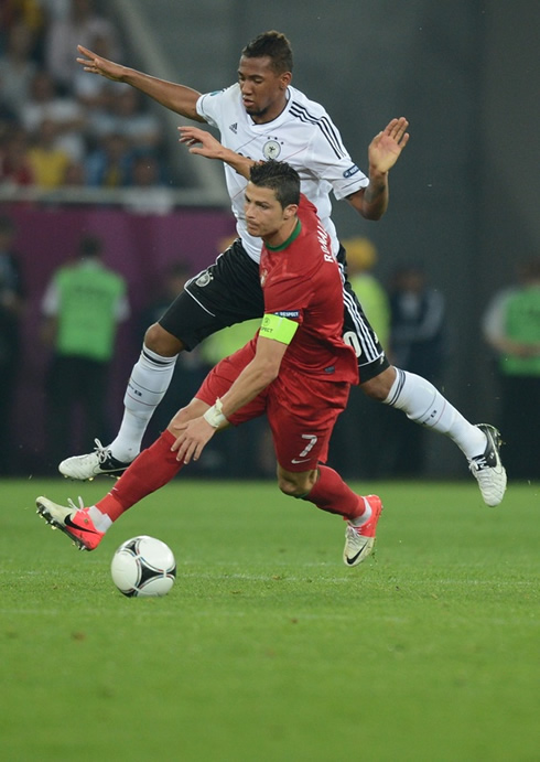 Cristiano Ronaldo protecting the ball from Boateng, in Portugal vs Germany for the EURO 2012