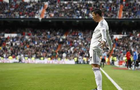 Cristiano Ronaldo celebrating a Real Madrid goal near the sideline of the Santiago Bernabéu