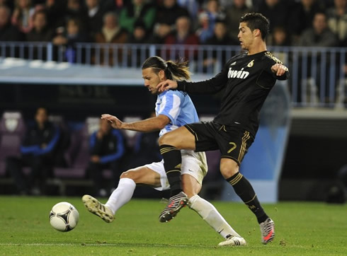 Cristiano Ronaldo trying to steal the ball from Demichelis