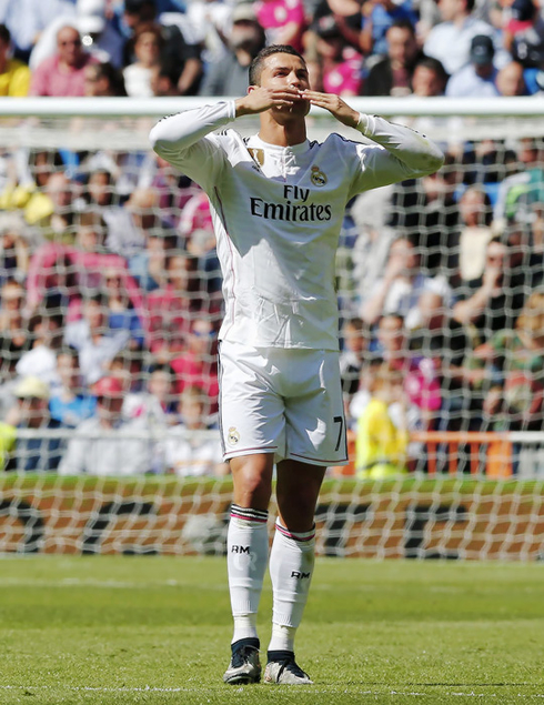 Cristiano Ronaldo blowing kisses out to the crowd and Real Madrid fans