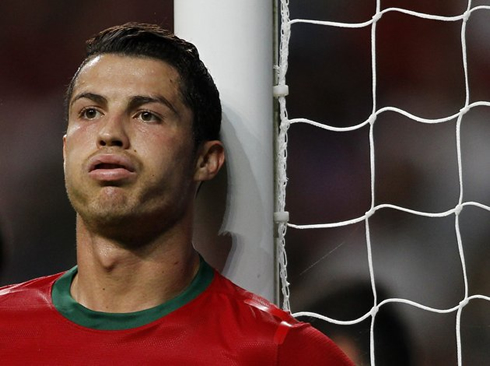Cristiano Ronaldo funny face as he blows and sighs, in a game for Portugal during a FIFA's 2014 World Cup qualification game