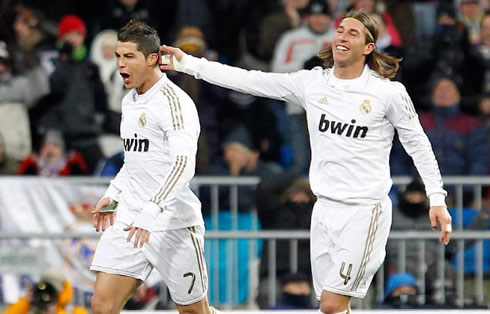 Cristiano Ronaldo smiles and celebrates a Real Madrid goal, while Sergio Ramos touches his hair