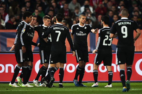 Real Madrid players celebrating another team goal in the middle of the park