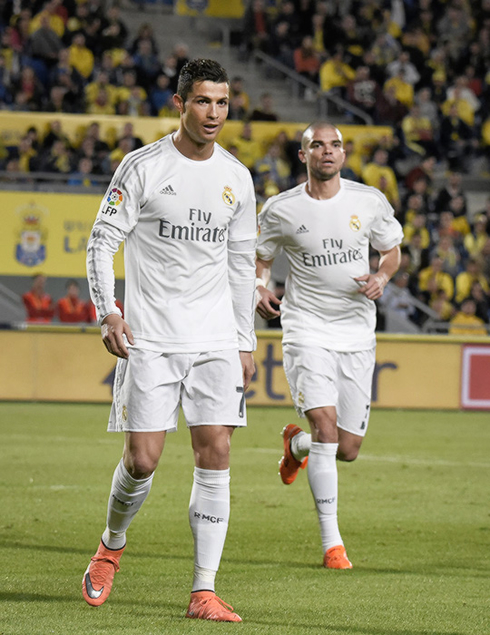 Cristiano Ronaldo and Pepe walk towards Sergio Ramos to join the goal celebrations