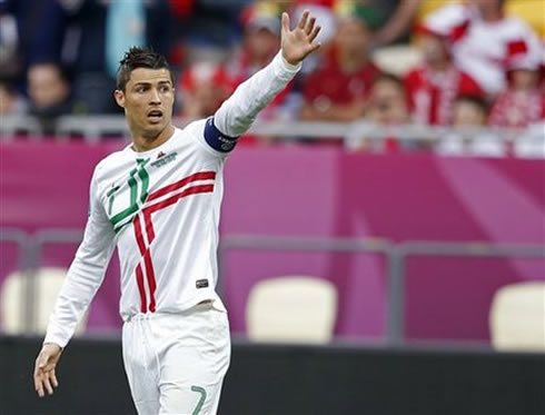 Cristiano Ronaldo raising his left arm and calling for someone's attention during the EURO 2012