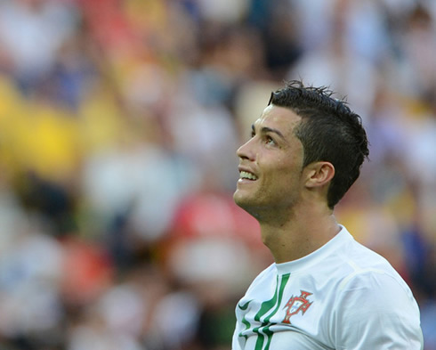 Cristiano Ronaldo smiling and looking above, in Portugal vs Denmark for the EURO 2012