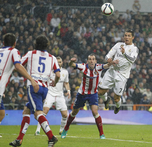 Cristiano Ronaldo jumping and anticipating Diego Godín to score a header in Real Madrid vs Atletico Madrid