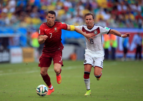 Cristiano Ronaldo running side by side with Mario Gotze, in their 2014 FIFA World Cup debut match between Germany and Portugal