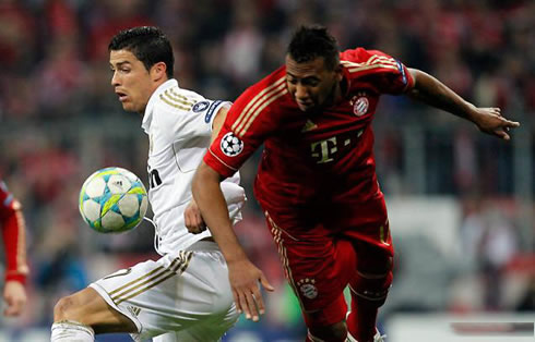 Cristiano Ronaldo disputing the ball with a Bayern Munich player, while playing for Real Madrid in the UCL in 2012