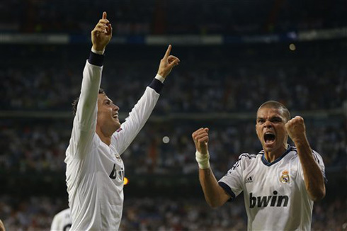 Cristiano Ronaldo pointing his fingers to the Santiago Bernabéu crowd, as he and Pepe celebrate Real Madrid goal against Manchester City, in 2012-2013