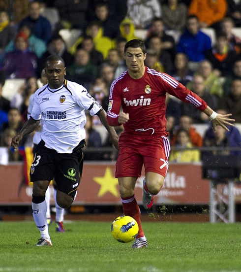 Cristiano Ronaldo running side-by-side with Miguel from Valencia CF