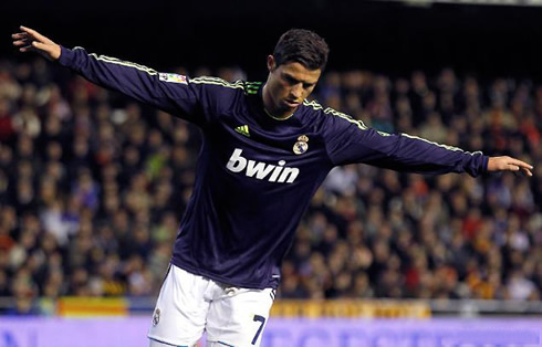Cristiano Ronaldo celebrating a goal for Real Madrid in a purple jersey, in 2013