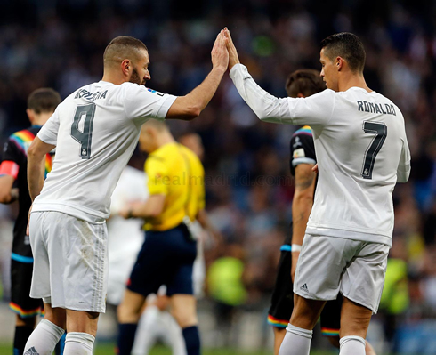 Cristiano Ronaldo doing a high five with Benzema