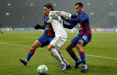 Mesut Ozil protects the ball from two CSKA defenders, in a Real Madrid game in 2012