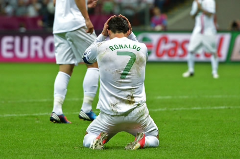 Cristiano Ronaldo on his knees, and holding his head after a goalscoring miss, at the EURO 2012