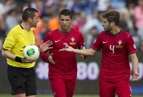 Cristiano Ronaldo and Miguel Veloso trying to understand the referee's explanations, during Israel vs Portugal, in a qualifier for Brazil's 2014 World Cup
