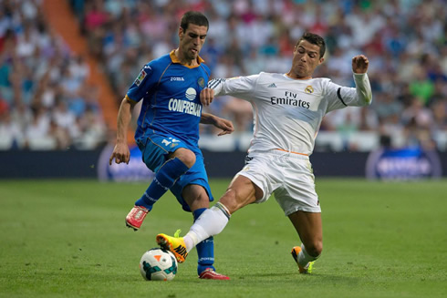 Cristiano Ronaldo in a defensive action, tackling an opponent