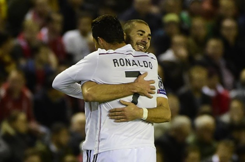 Cristiano Ronaldo and Karim Benzema hugging each other in Anfield Road