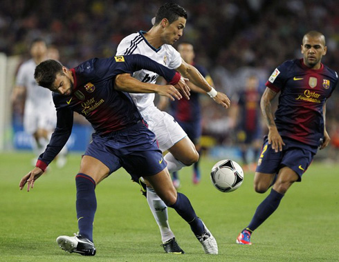 Gerard Piqué challenging Cristiano Ronaldo to win a ball that was bouncing on the pitch, in Barcelona vs Real Madrid in 2012