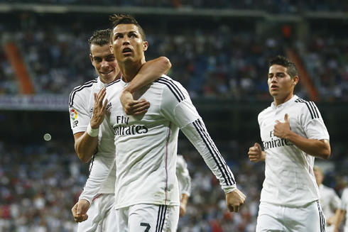 Cristiano Ronaldo being hugged by Bale as James Rodríguez prepares to join the celebrations