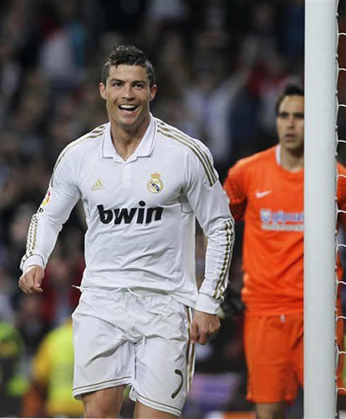 Cristiano Ronaldo walks away to celebrate a Real Madrid goal, with a big smile on his face