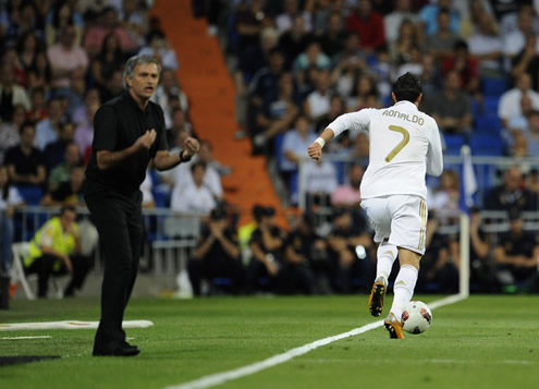 Cristiano Ronaldo running while José Mourinho gives instructions to some other player, in La Liga Real Madrid vs Rayo Vallecano 2011-2012
