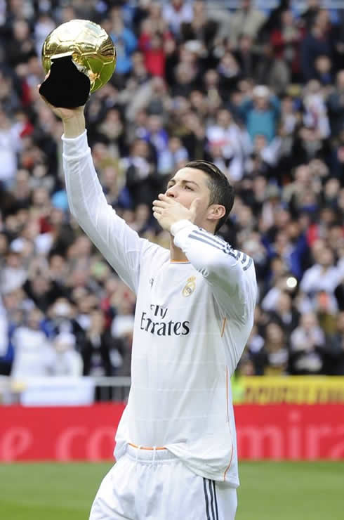 Cristiano Ronaldo sending kisses to the fans as he shows them the FIFA Ballon d'Or
