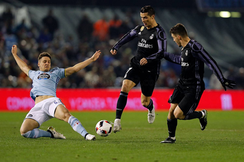 Cristiano Ronaldo trying to avoid a sliding tackle from a Celta de Vigo opponent