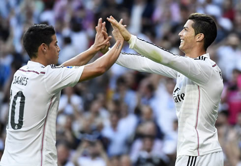 James Rodríguez and Cristiano Ronaldo holding hands in the Clasico