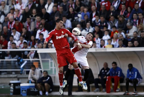 Cristiano Ronaldo jumping to head the ball with a Rayo Vallecano opponent