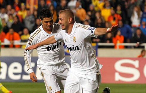 Karim Benzema starting to run to celebrate a goal for Real Madrid, with Cristiano Ronaldo chasing him