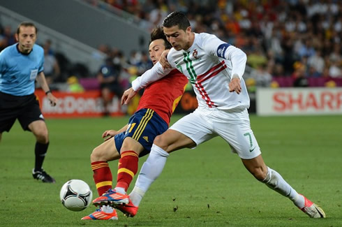 Cristiano Ronaldo pushing David Silva as he attempts to get the ball possession, in Portugal vs Spain for the EURO 2012