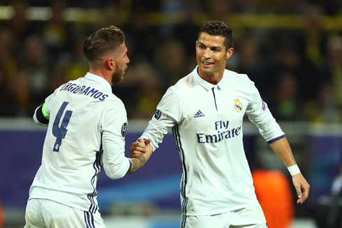Sergio Ramos and Cristiano Ronaldo smiling at each other after a Real Madrid goal