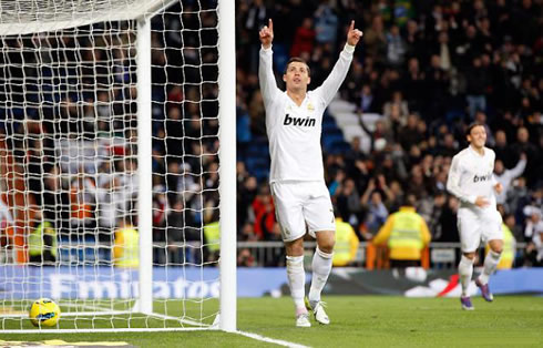 Cristiano Ronaldo dedicating the goal to someone from his family in the crowd, by raising his two arms and pointing two fingers to the sky, in La Liga 2012