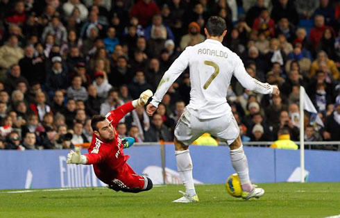 Cristiano Ronaldo scoring a goal against Roberto from Zaragoza, in a Real Madrid game for La Liga 2011/2012