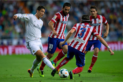 Cristiano Ronaldo getting past Filipe Luís, in Madrid between Real and Atletico, in 2013